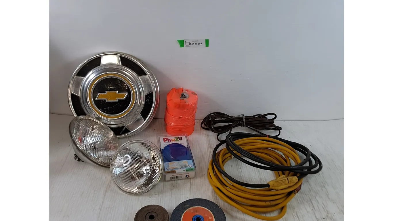 (2) Lamp Bulbs, (3) Power Cords Untested, (2) Grinding Wheels, Surveyor's Tape, Chevy Hubcap