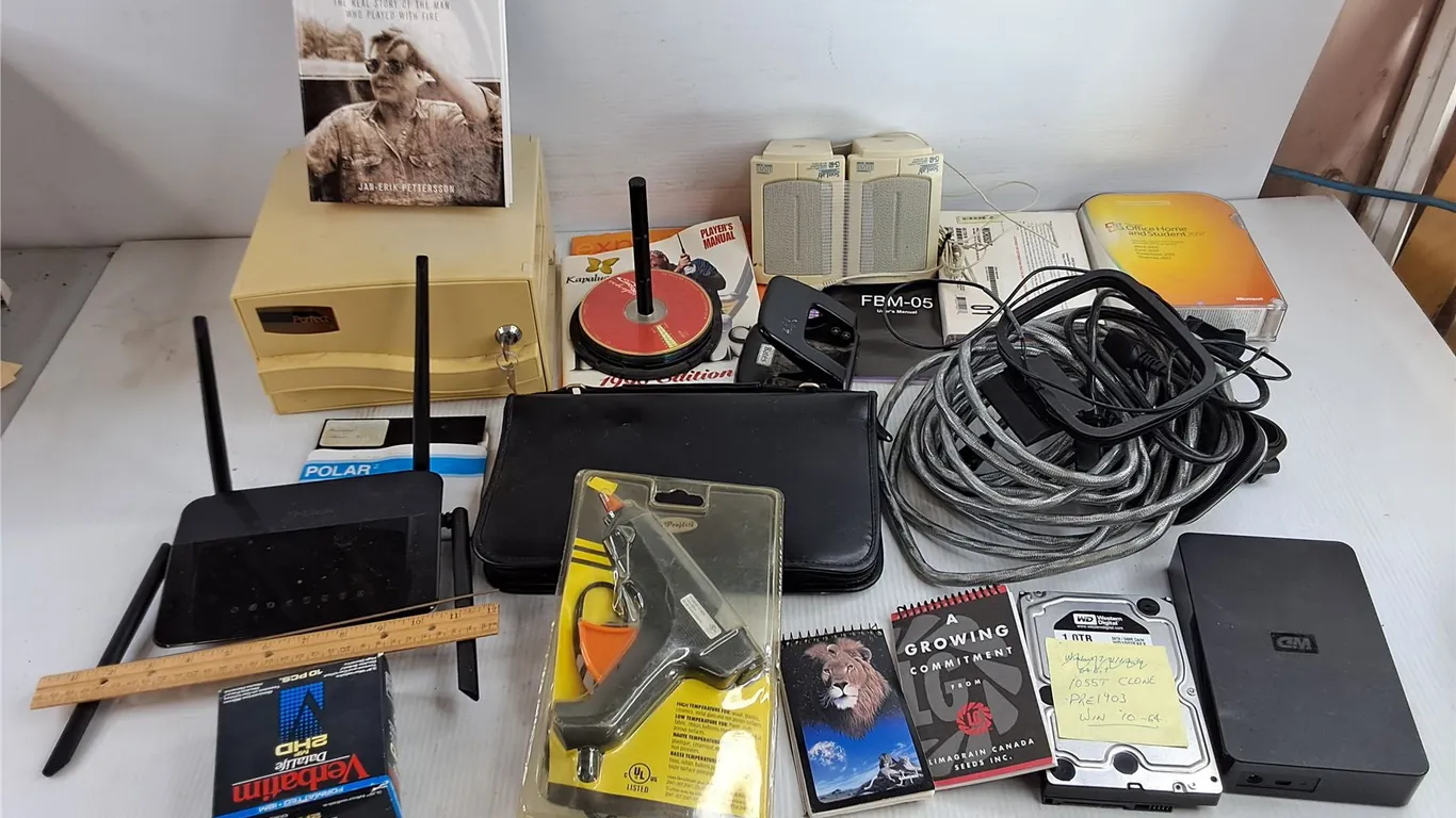 Speakers, CD Bag, D Link Wifi Router, WD Hard Drive, Paper Hole Punch, Glue Gun, Misc