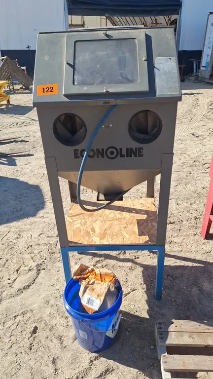 Econoline sand blaster with a pail of abrasive