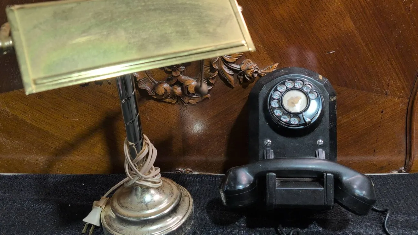 Brass Desk Lamp and Black Rotary Wall Telephone