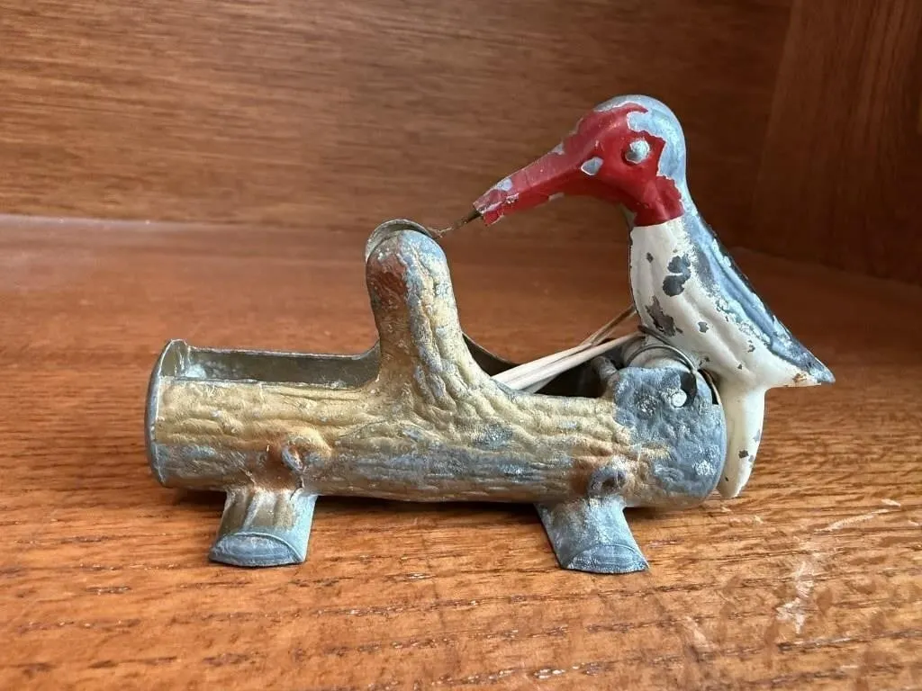 Woodpecker toothpick dispenser