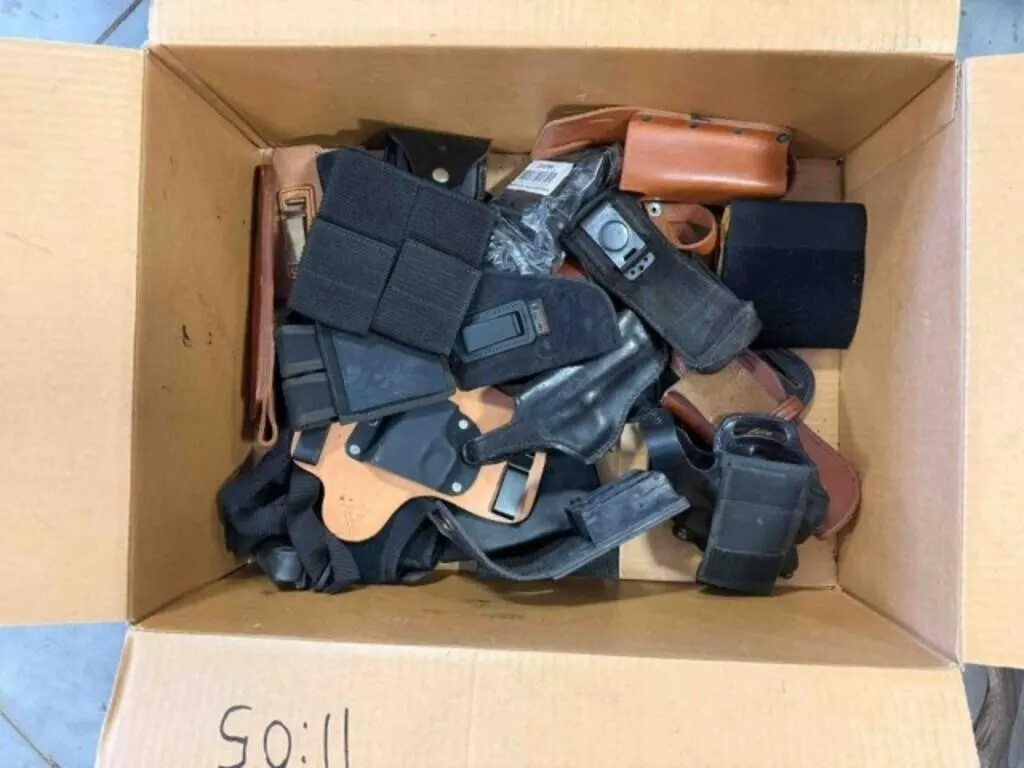 box of misc. pistol holsters, magazine holders