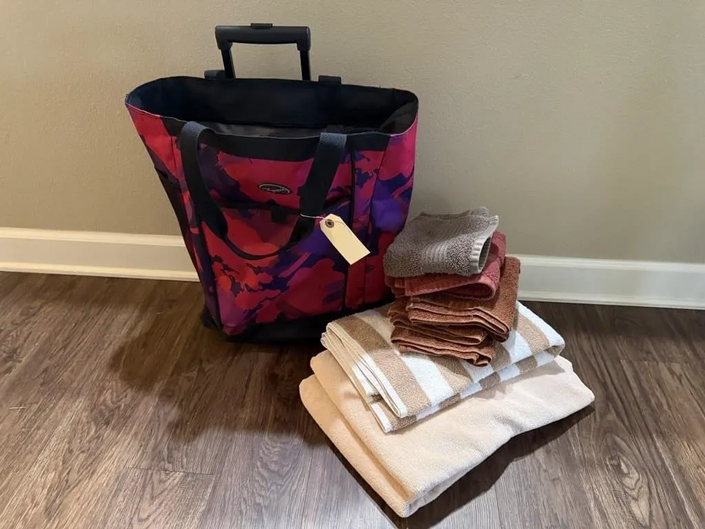 Rolling carry on bag, bath towels, hand towels