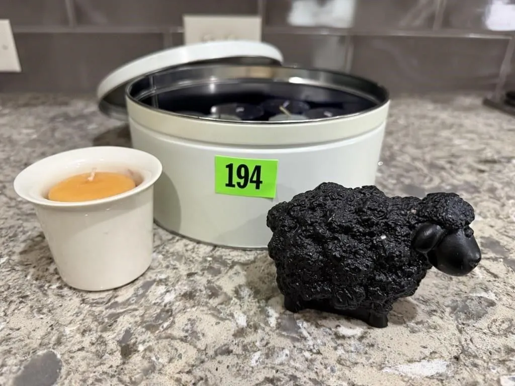 Cookie tin, votive candles, black sheep