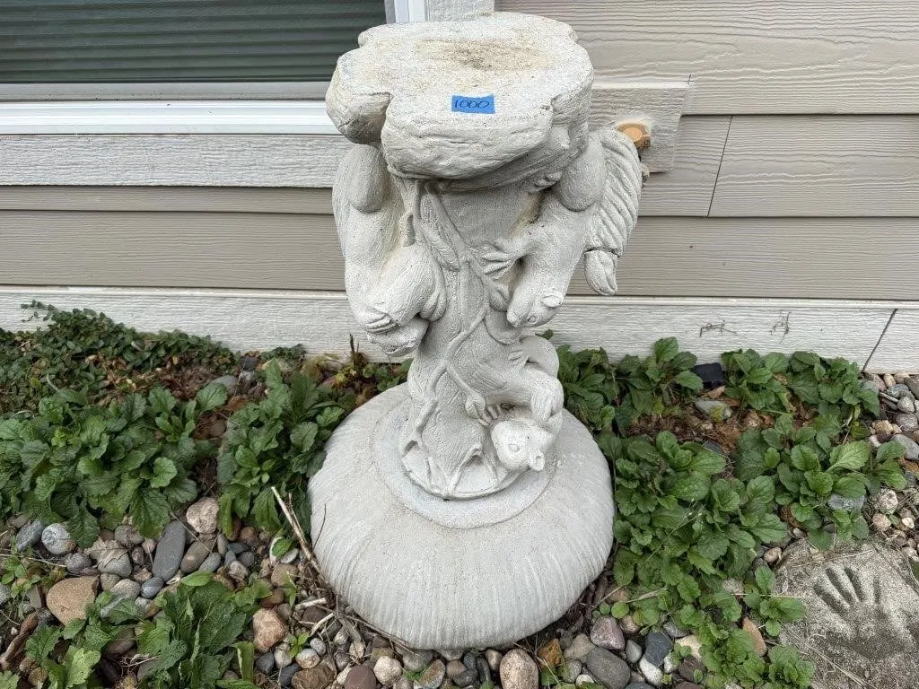Concrete squirrel bird bath