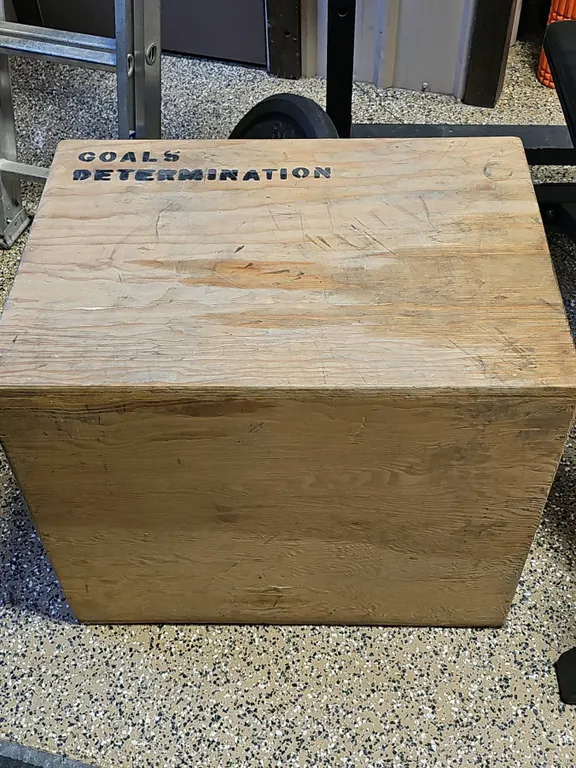 Wooden Plyometric Jump Box With 'Goals Determination' Text And Handholds