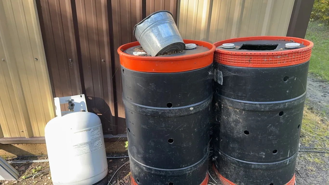 Two Plastic Bear Bait Drums with Red Trim and Propane Cylinder