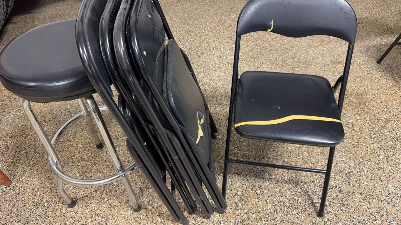 Four Black Metal Folding Chairs with Black Padded Stool