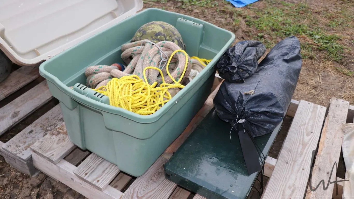 Military helmet, heavy cord, rope, tent, camp stove