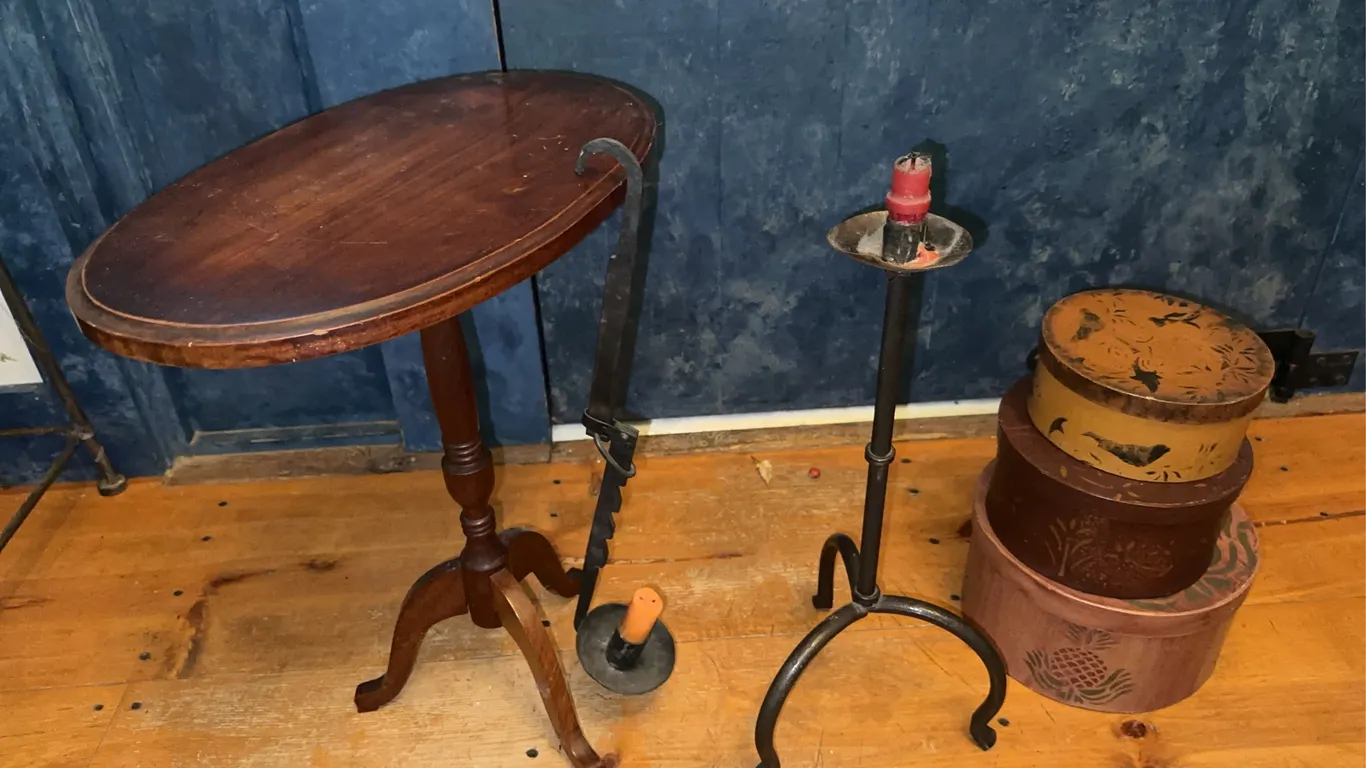 Vintage vignette - nesting boxes, small table and wrought iron candlestick