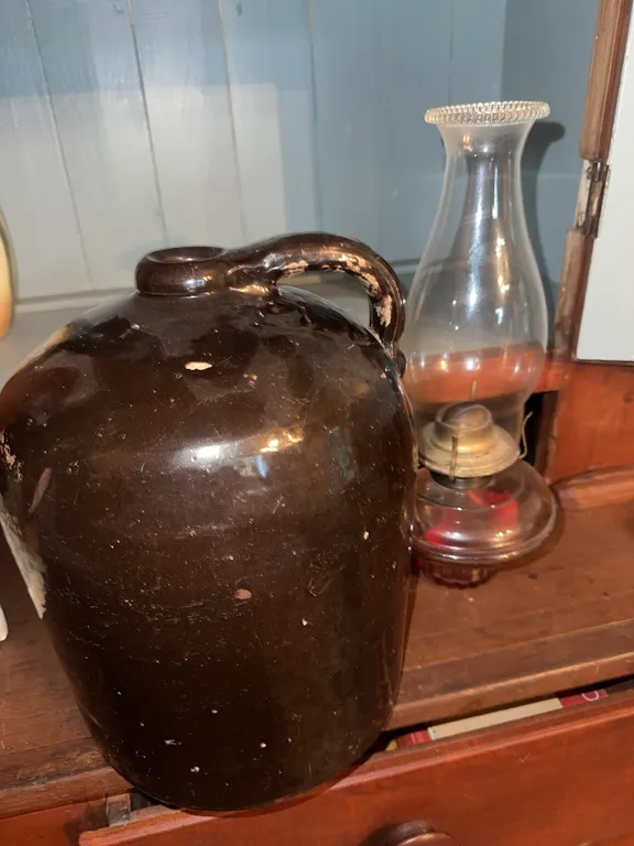 Large stoneware jug and oil lamp