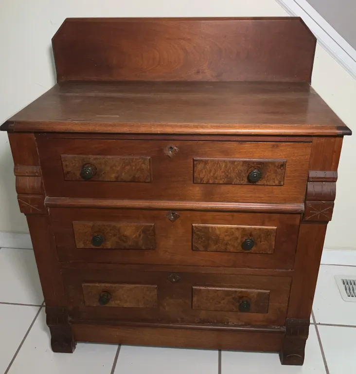 Victorian-Era Wooden Chest of Drawers Featuring a Raised Back Splash