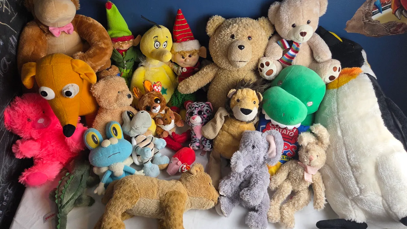 Large collection of assorted stuffed animals and plush toys