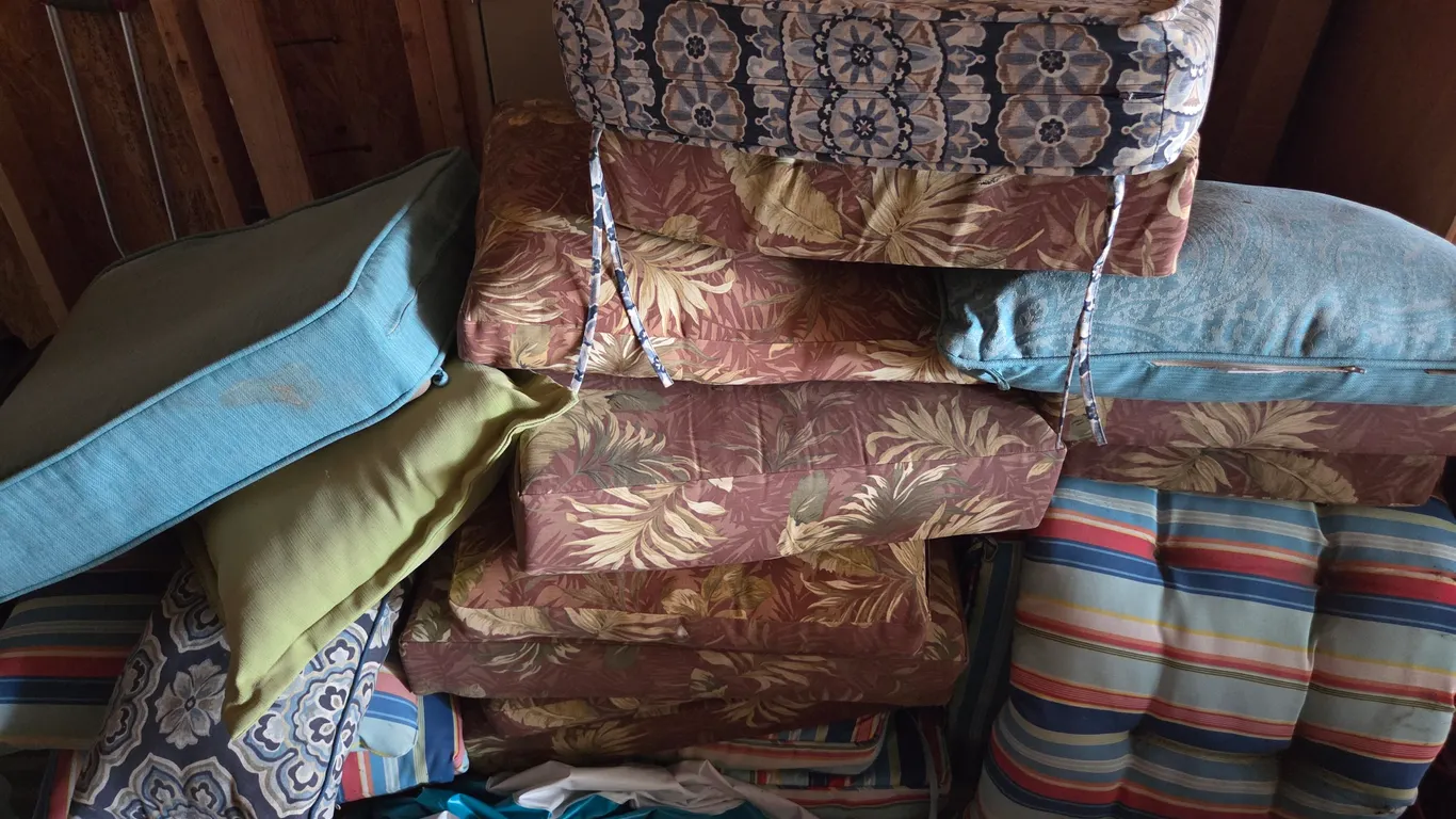 Pile of outdoor furniture cushions