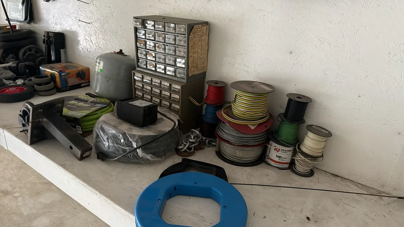 Unused FlexZilla 50' 3/8" air hose w/ pintle hitch, unused 50' power cord, steel fish tape reel, elec wire, hardware assortment & implement wheels