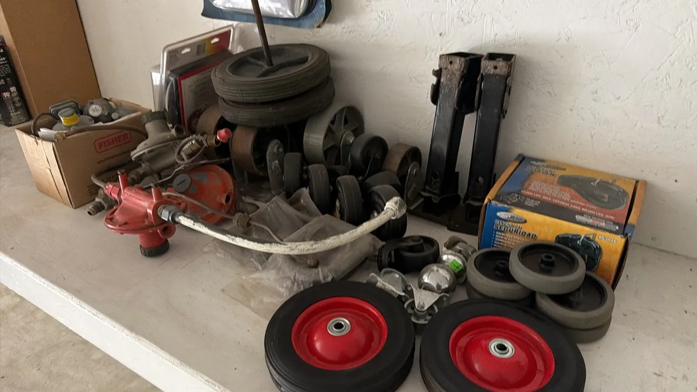 Assorted caster wheels, LP regulators, unused pintle hook & GMC factory splash guards