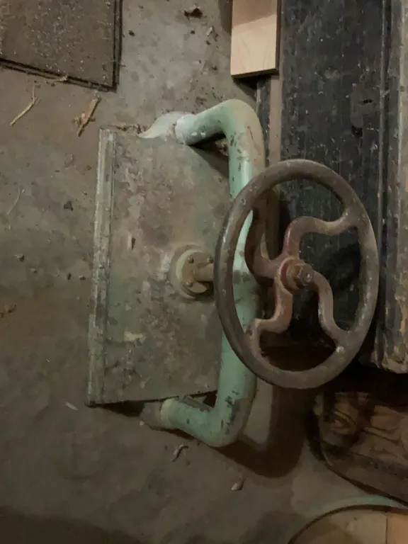 Large Industrial Iron Valve Wheel with Attached Pipe Section