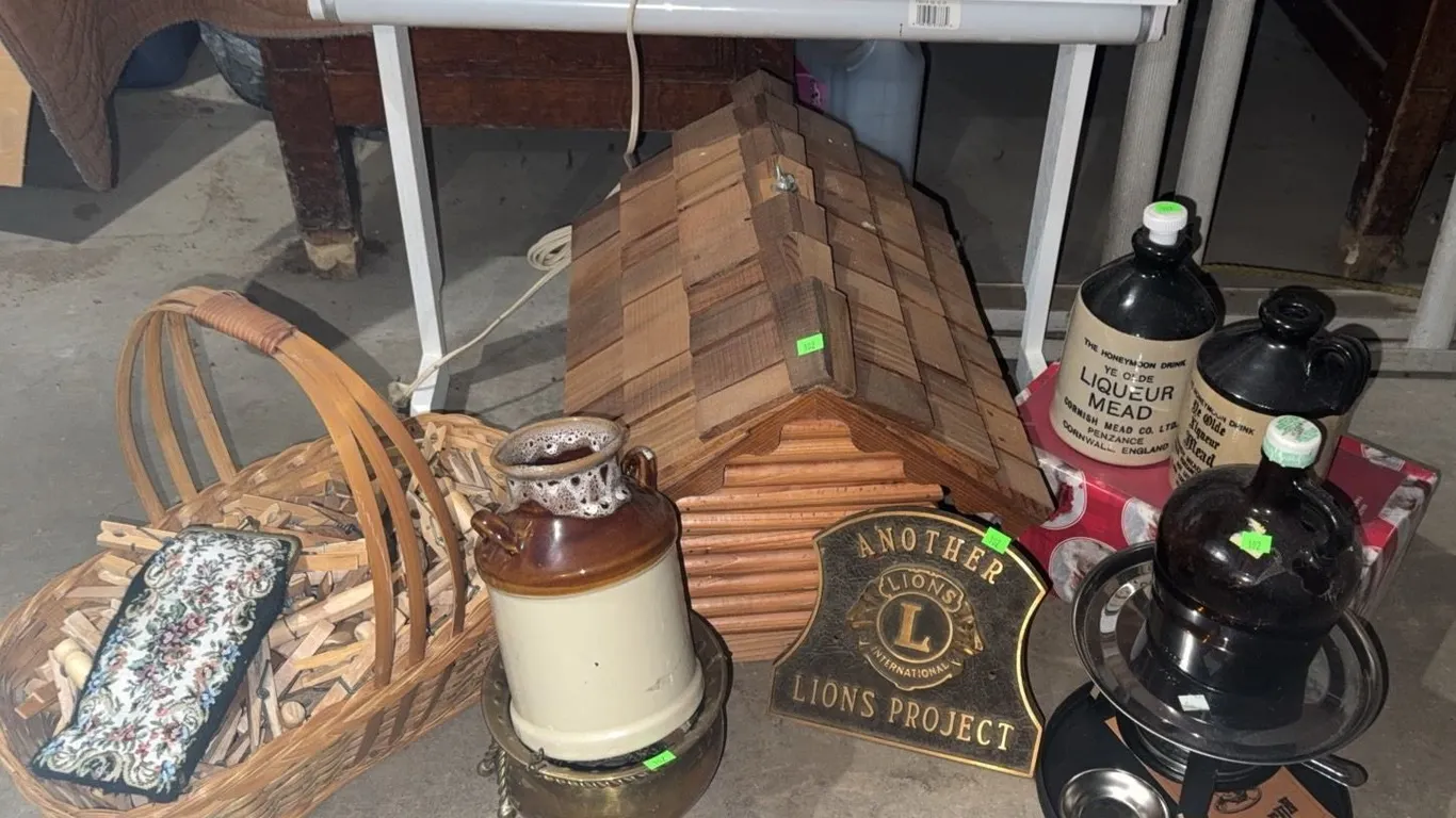 Household Items Including Wooden House, Lions Project Plaque, and Basket