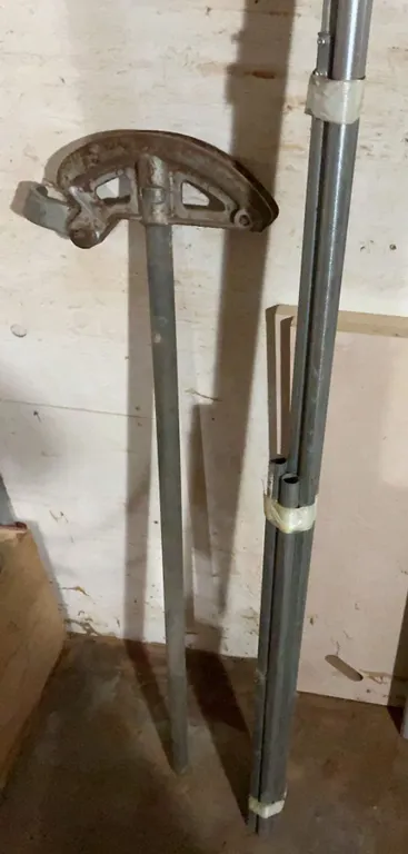 Metal Conduit Bender and Set of Metal Pipes