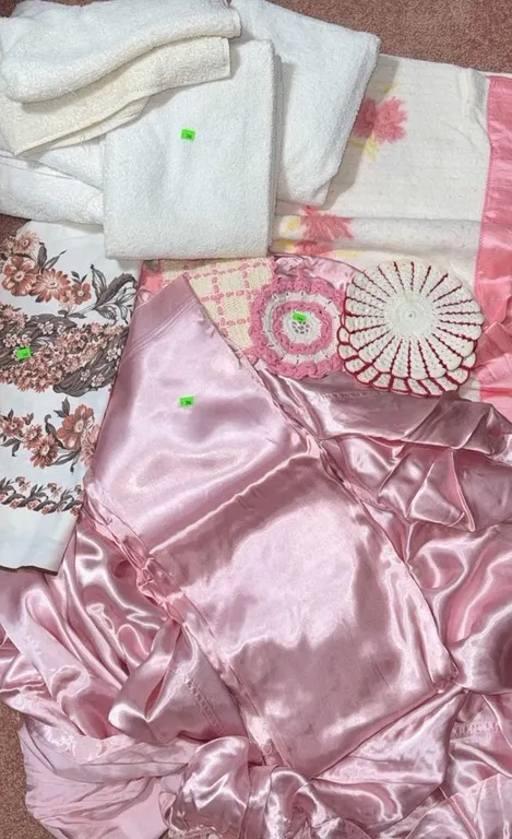 Linens Including Pink Satin, Floral Print, Crochet, and Terrycloth Towels