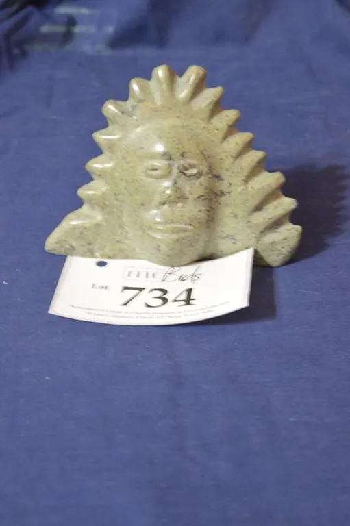 Carving Of A Man's Face In His Fur-Trimmed Hood.
