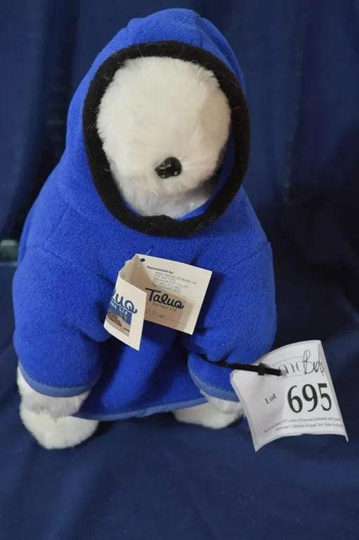 A Large, Stuffed, Polar Bear With Blue Parka