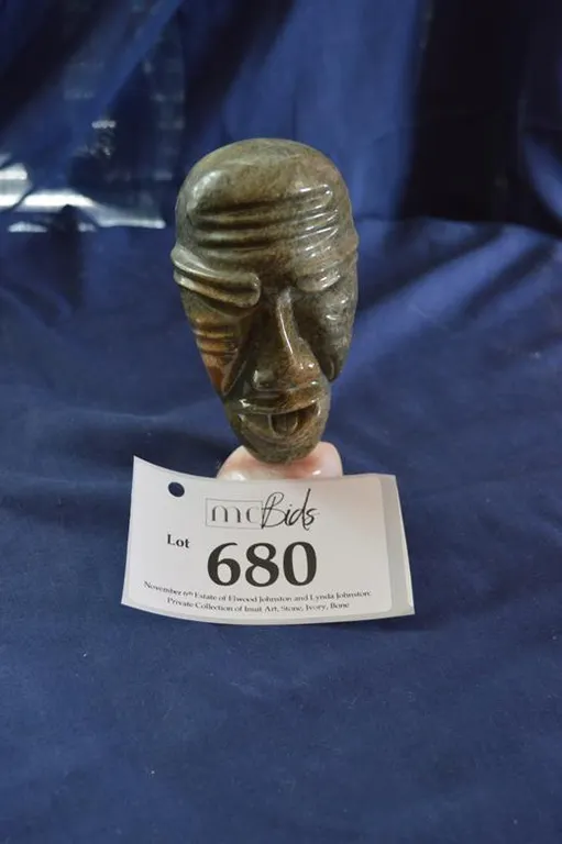 An Inuit Face On Marble Stand.