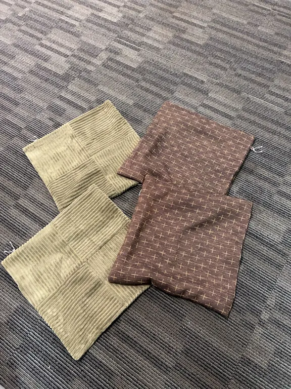 Four Textile Cushion Covers in Corduroy and Patterned Fabric