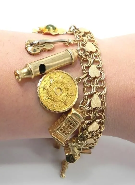 14KT GOLD CHARM BRACELET 58.92g $12,800.00