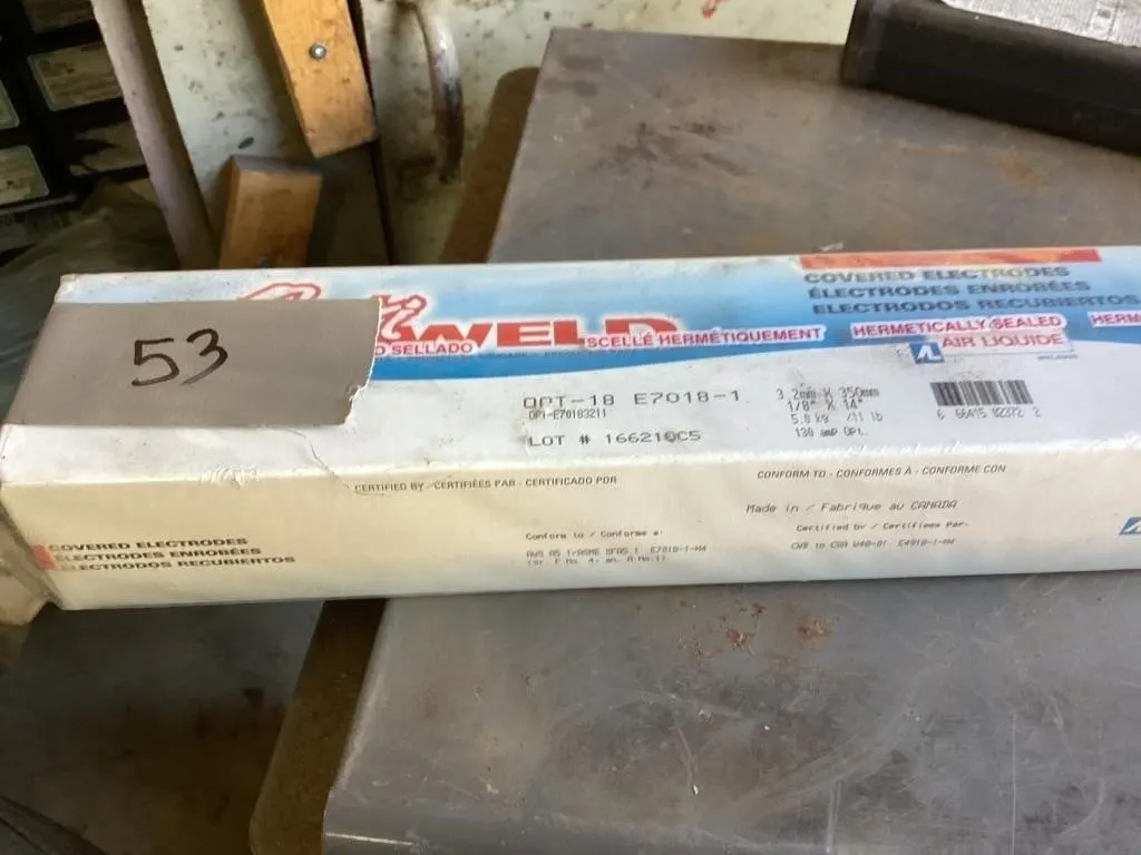Five sealed boxes 7018 welding rods