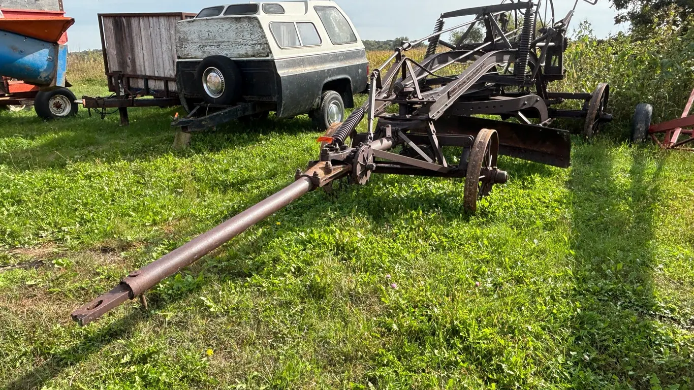 Adam Leaning Steel Wheeled Grader