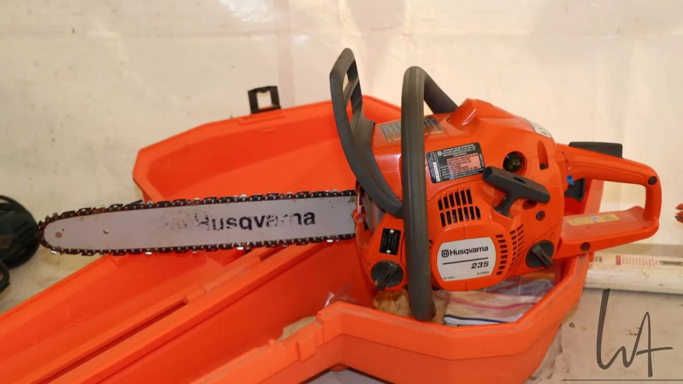 Husqvarna model 235 chain saw with case, engine turns freely and has compression
