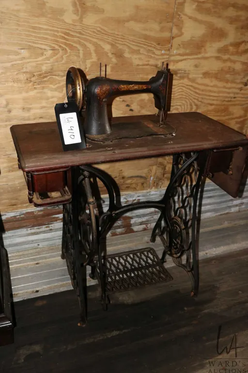 Antique Singer sewing machine in treadle cabinet