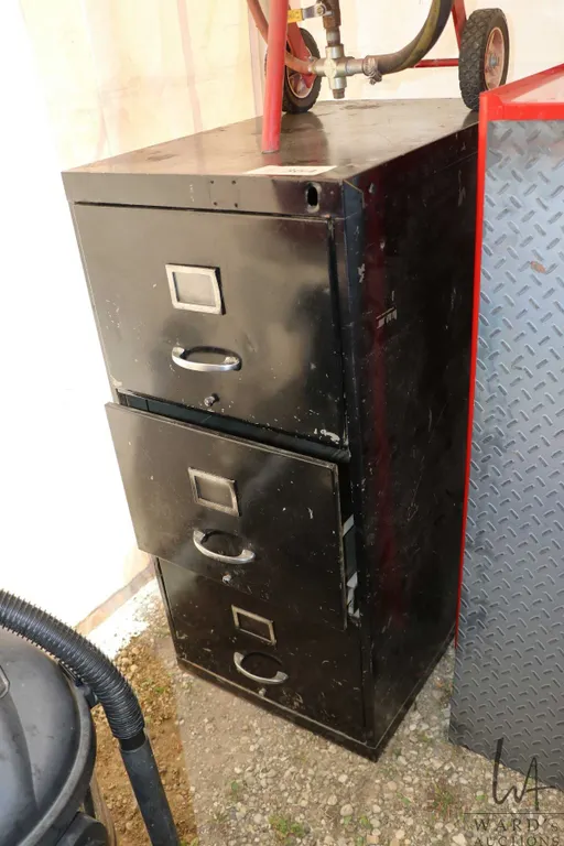 Metal filing cabinet containing pneumatic rivet gun, oil filter wrenches etc.