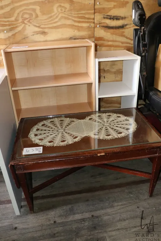 Two open wooden shelves and an antique coffee table