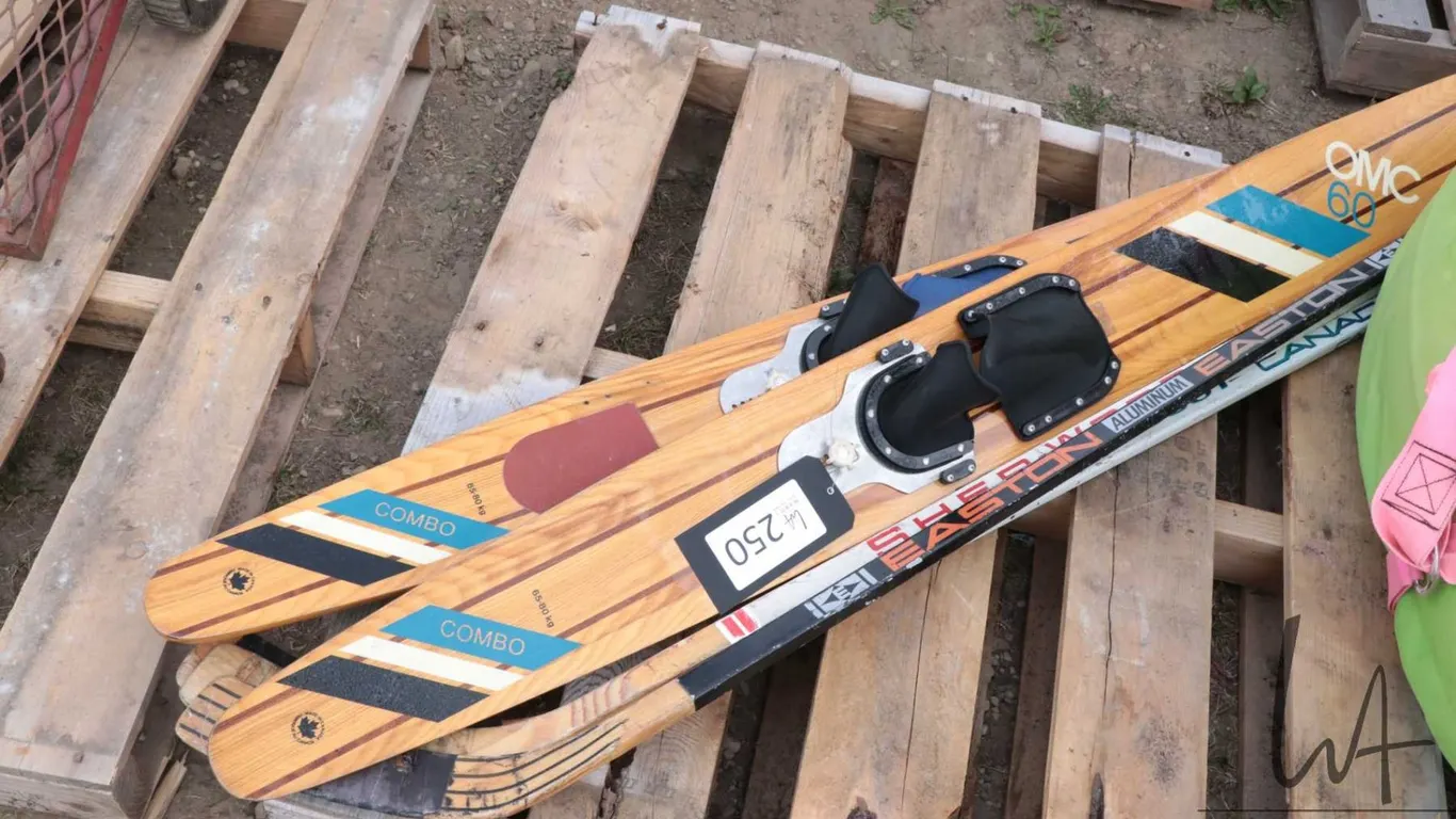 Pair of OMC 60 water skis and two hockey sticks