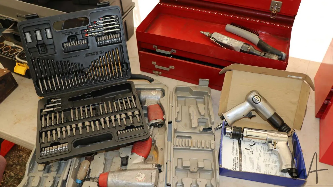 Selection of tools including pneumatic impacts, drill and hammer plus molded plastic case with drill