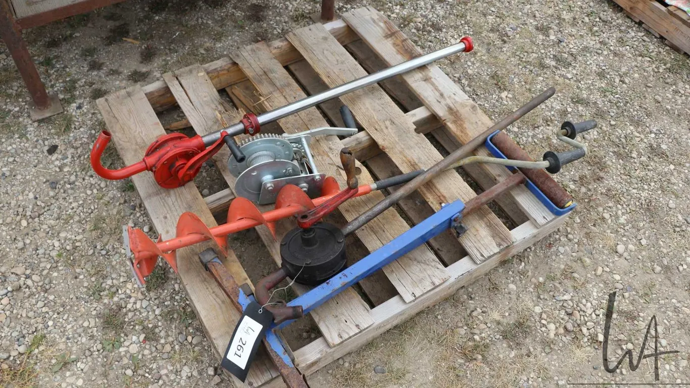 Ice auger, two fluid pumps and a roller stand