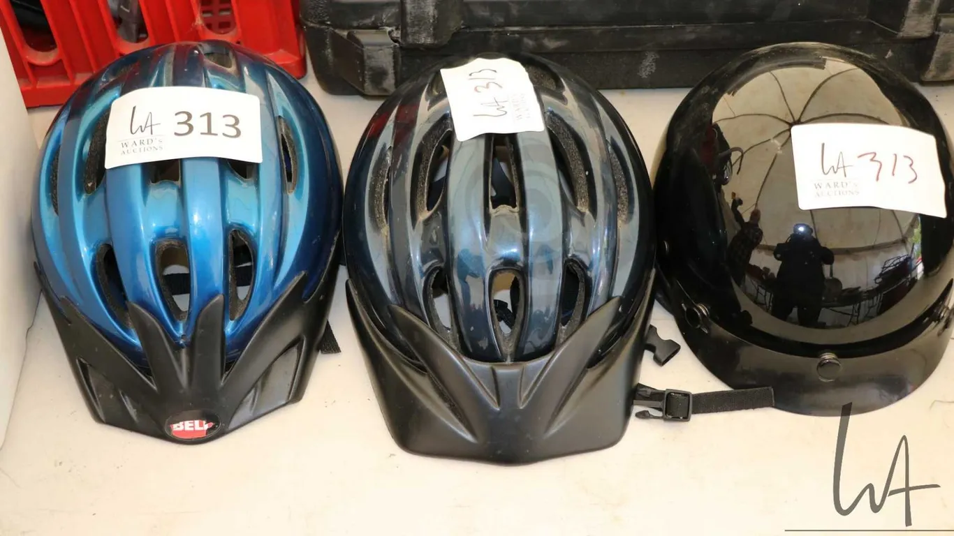 Two bicycle helmets and one small size motorcycle helmet