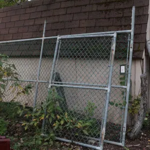 Section of chain link fence, 142"w x 84" h including barb wire section, plus a 46"w gate