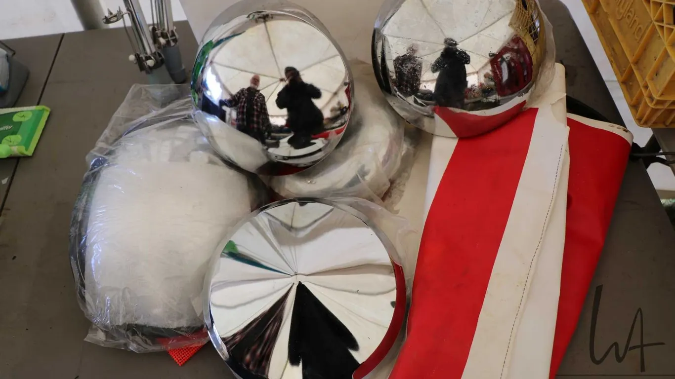 Selection of heavy truck hub caps, a side mirror and flags