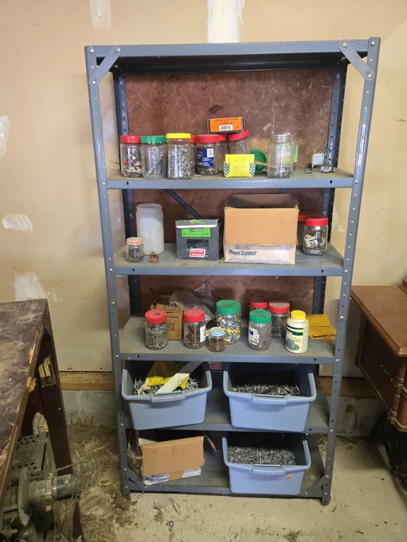 Metal shelving unit and contents full of hardware nuts bolts nails