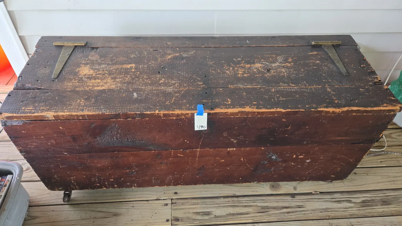 Vintage wooden footlocker on casters