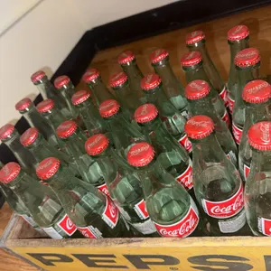 28 Vintage Coca-Cola bottles with caps.
