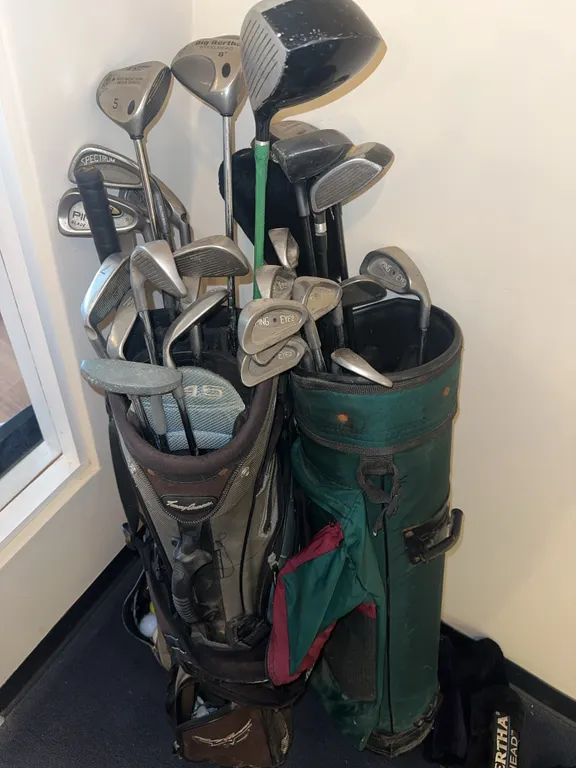 Two sets of golf clubs and bags-Big Berthas etc