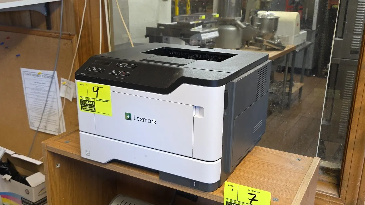 Lexmark MS421 laser printer. Features front paper cassette tray, fold-down multipurpose feeder, and top control panel with LCD display. Machine type: