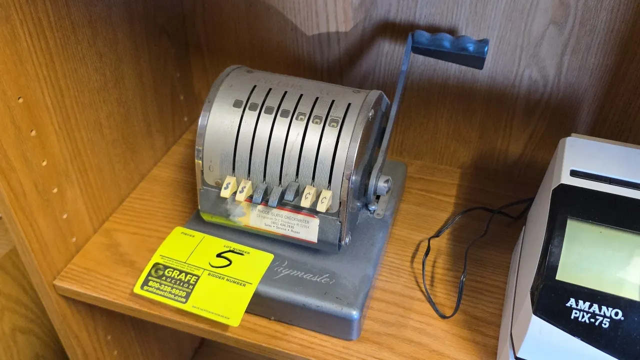 Paymaster Series X-550 7-column mechanical checkwriter. Features manual crank handle, 7 sliding column selectors, and metal housing. S/N: 4526522. Tim