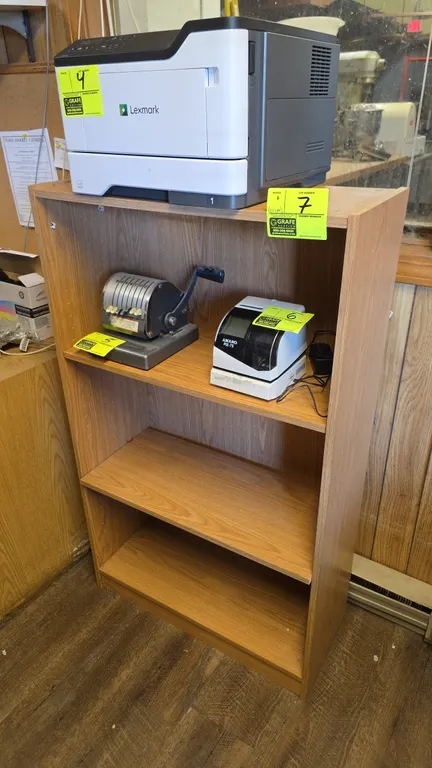 Laminate wood shelves. Includes a 48" 4-tier bookcase and a 28" 2-tier shelf unit. Features oak-look laminate finish. Contents and surrounding equipme