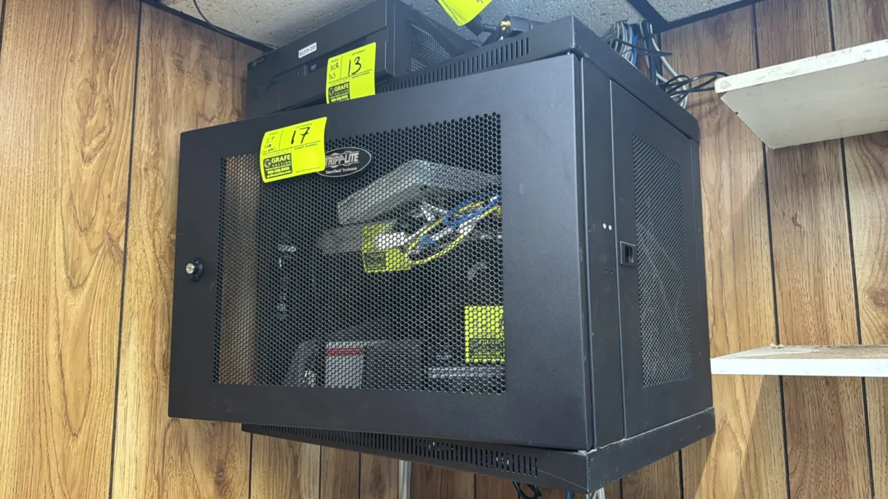 Tripp-Lite SRW9U wall-mount IT rack enclosure cabinet. Features 9U capacity, perforated mesh locking front door, and vented side panels. Dimensions: 2