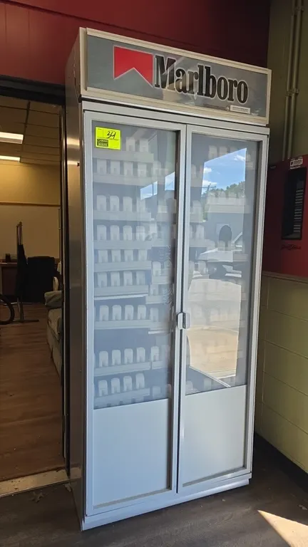 Marlboro French door tobacco display case. Features dual hinged doors, branded Marlboro header panel, and multi-tier adjustable cigarette pack pusher